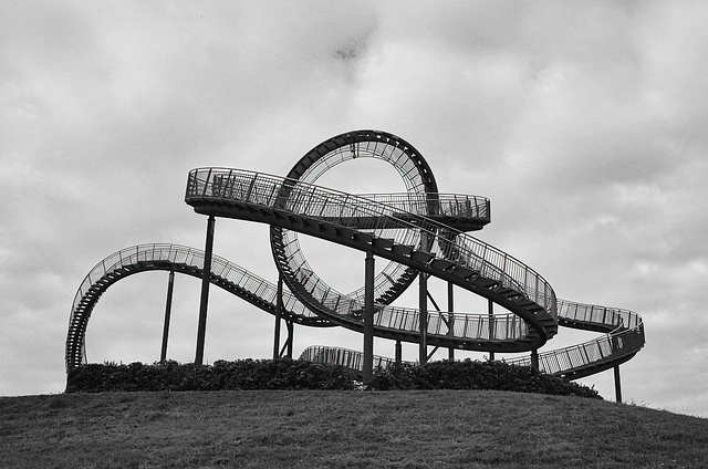 A black and white photo of an abandoned roller coster | Photo by: @the_iop at Pixabay
